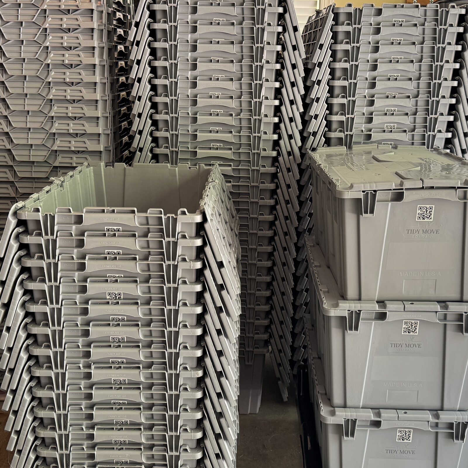 Stack of three sage green stackable reusable moving totes