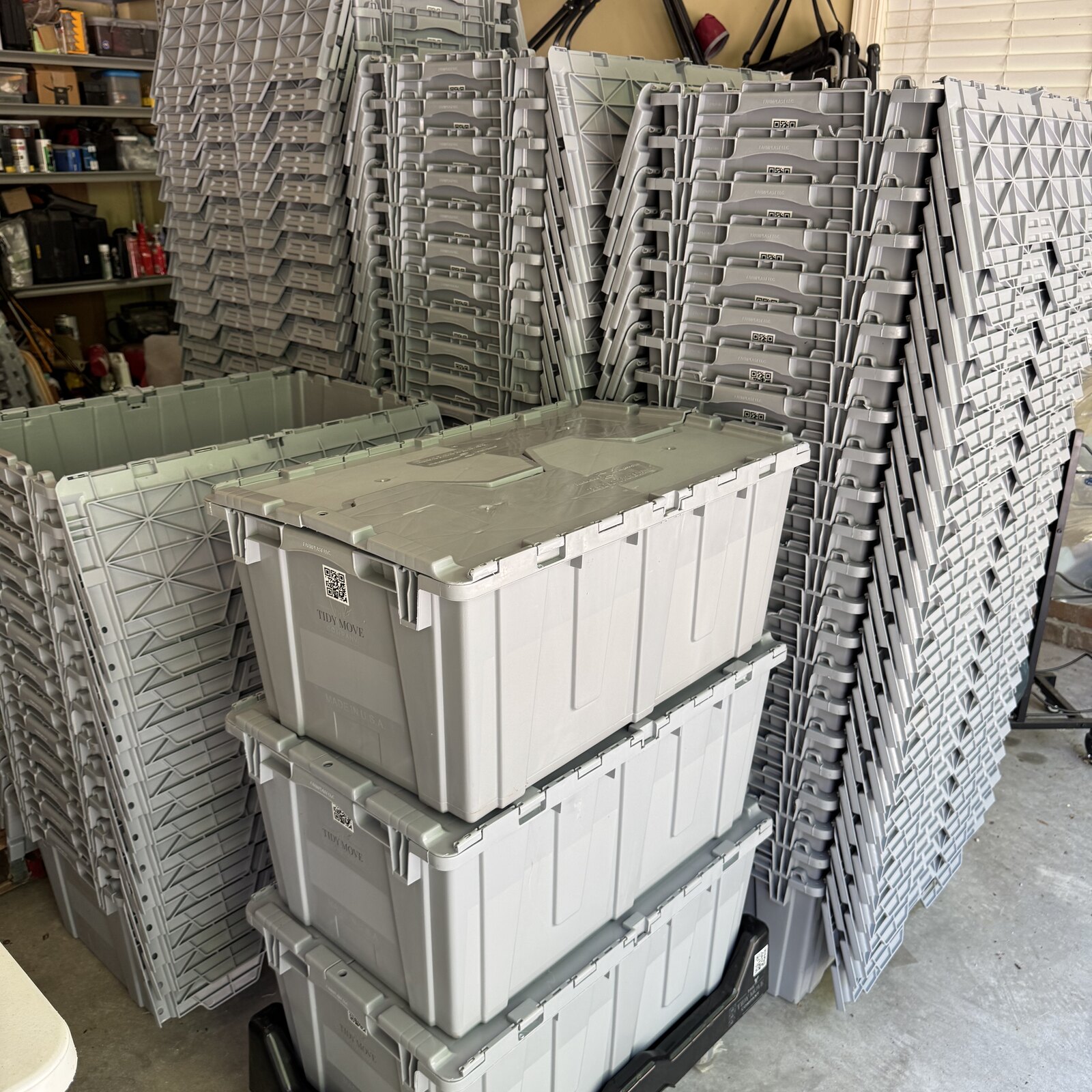 Stack of sage green and cream reusable moving totes by The Tidy Move Co. in Wake Forest, NC
